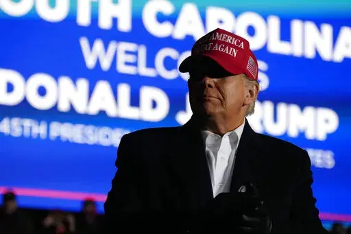 Former President Donald Trump arrives at a rally, Saturday, March 12, 2022, in Florence, S.C. Trump has endorsed two Republicans mounting primary challenges to sitting House members who have been critical of him. (AP Photo/Meg Kinnard)