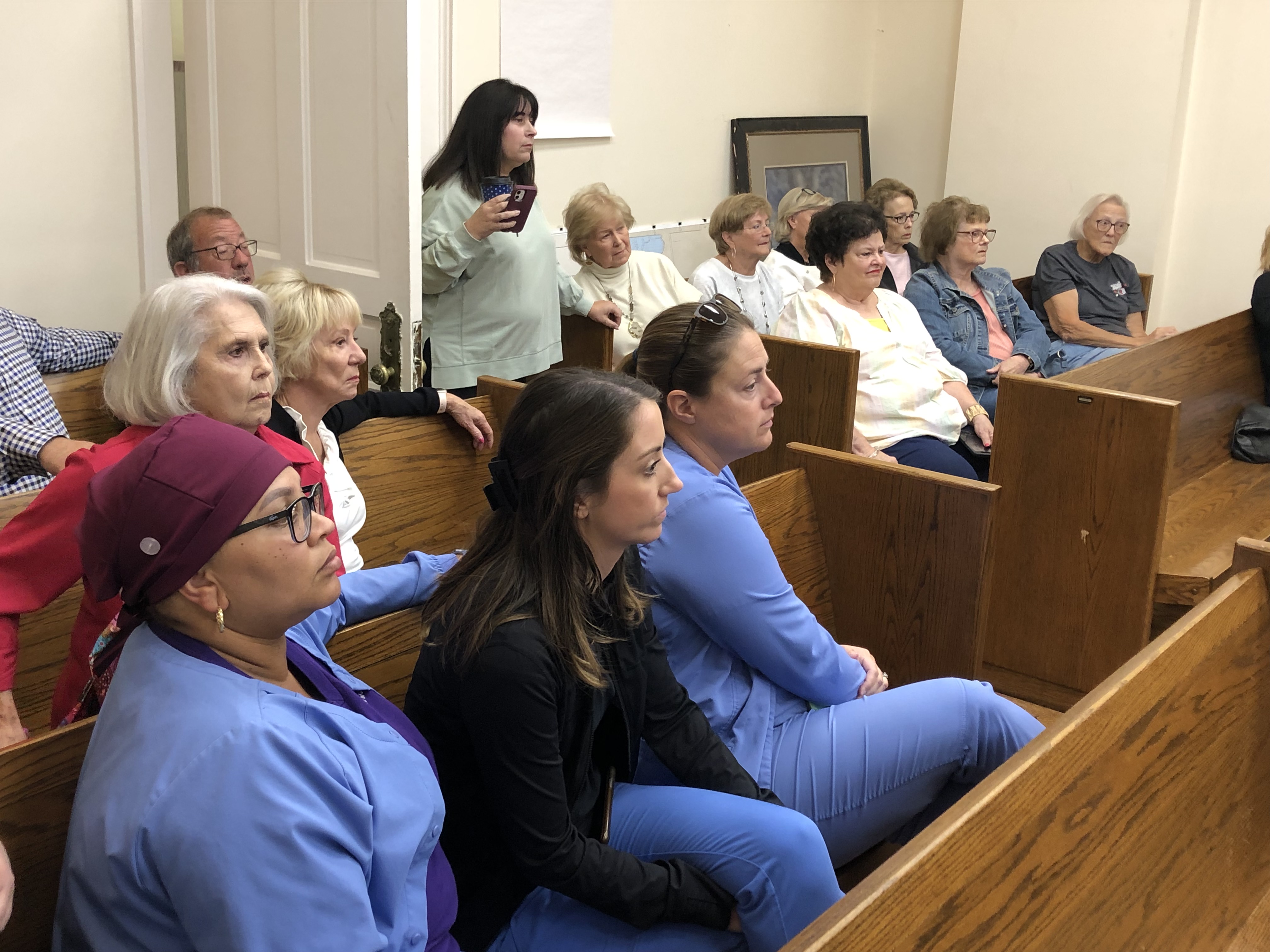 Mel Harris and audience at county board meeting