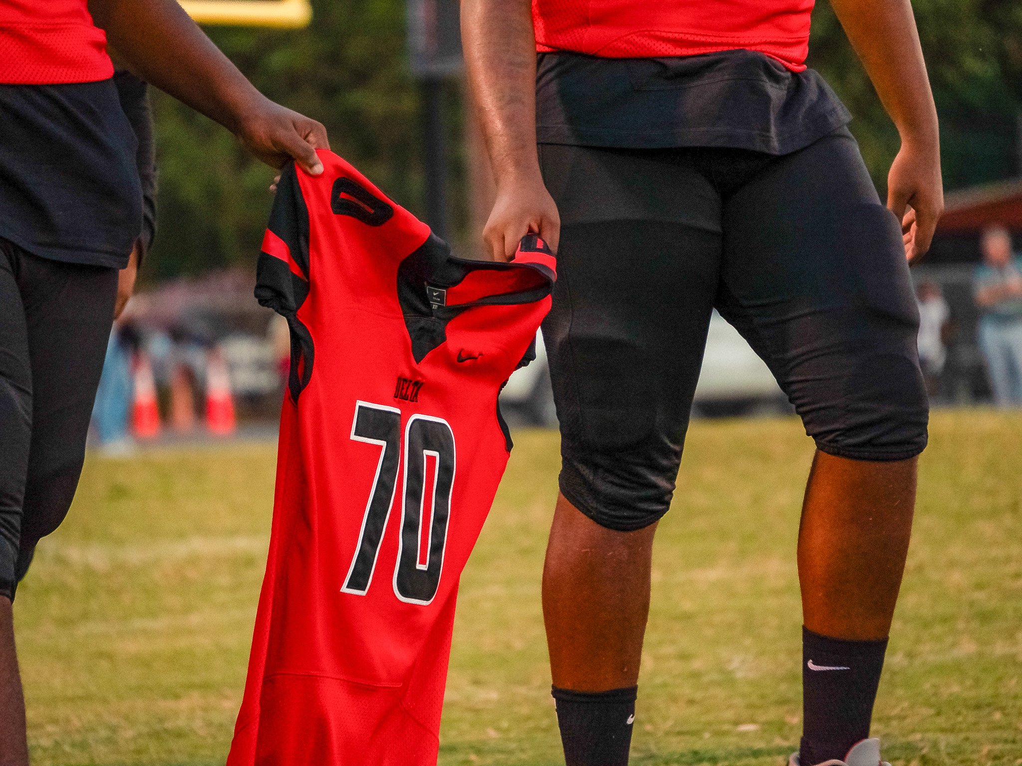 Trojan Players Hold Fallen Teammates Jersey
