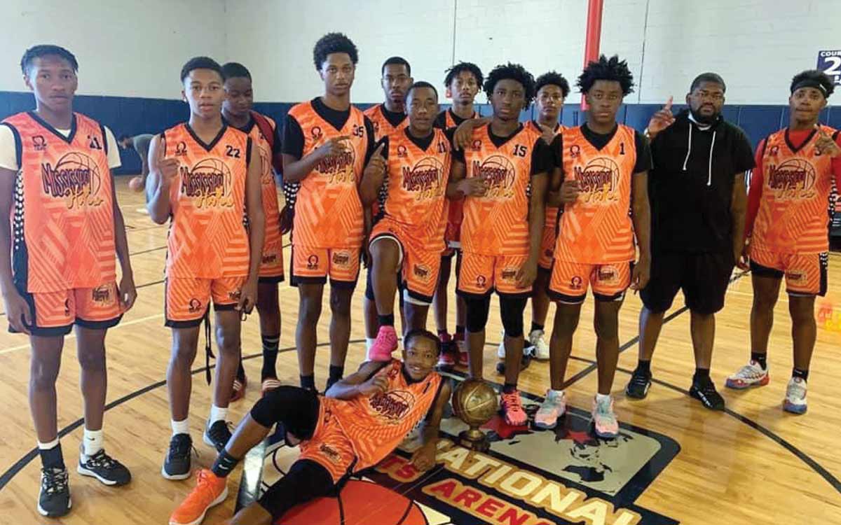 CLARKSDALE HUSTLERS older boys team holds the trophy after winning their tournament in Atlanta.