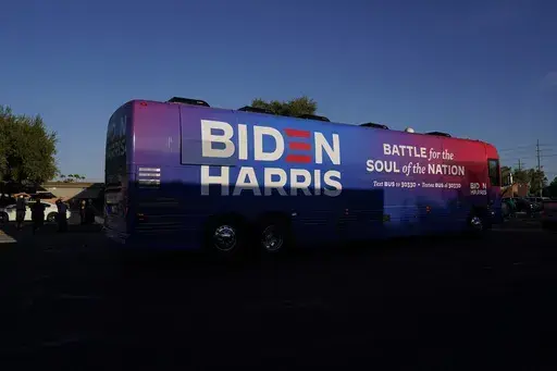 Democratic presidential candidate former Vice President Joe Biden and Democratic vice presidential candidate Sen. Kamala Harris, D-Calif., ride on a bus in Phoenix, Oct. 8, 2020, on a small business bus tour. (AP Photo/Carolyn Kaster, File)
