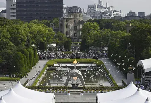 Doves fly over the cenotaph dedicated to the victims of the atomic bombing during an annual ceremony marking the 79th anniversary of the world's first atomic bombing, at the Peace Memorial Park in Hiroshima, western Japan, Tuesday, Aug. 6, 2024. (Yu Nakajima/Kyodo News via AP)