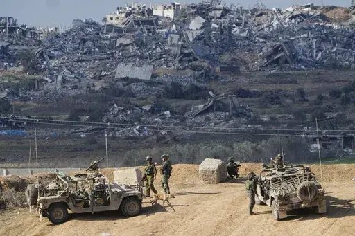 Israeli soldiers take up positions near the Gaza Strip border, in southern Israel, Friday, Dec. 29, 2023. The army is battling Palestinian militants across Gaza in the war ignited by Hamas' Oct. 7 attack into Israel. Israel and Hamas have been at war for 100 days. The war already is the longest and deadliest between Israel and the Palestinians since Israel’s establishment in 1948, and the fighting shows no signs of ending. (AP Photo/Ariel Schalit, File)