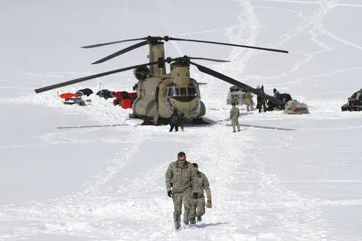  Capt. Corey Wheeler, front, commander of B Company, 1st Battalion, 52nd Aviation Regiment at Fort Wainwright, Alaska, walks away from a Chinook helicopter that landed on the glacier near Denali, April 24, 2016, on the Kahiltna Glacier in Alaska. The U.S. Army helped set up base camp on North America's tallest mountain. The U.S. Army is poised to revamp its forces in Alaska to better prepare for future cold-weather conflicts, and it is expected to replace the larger, heavily equipped Stryker Bri