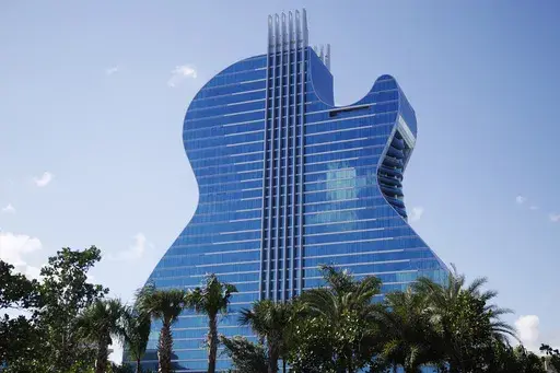 The guitar shaped hotel is seen at the Seminole Hard Rock Hotel and Casino on Thursday, Oct. 24, 2019, in Hollywood, Fla. The state of Florida and the Seminole Tribe of Florida will be raking in hundreds of millions of dollars from online sports betting this decade, thanks to a compact between the tribe and Gov. Ron DeSantis that gave the tribe exclusive rights to run sports wagers as well as casino gambling on its reservations. (AP Photo/Brynn Anderson, File)