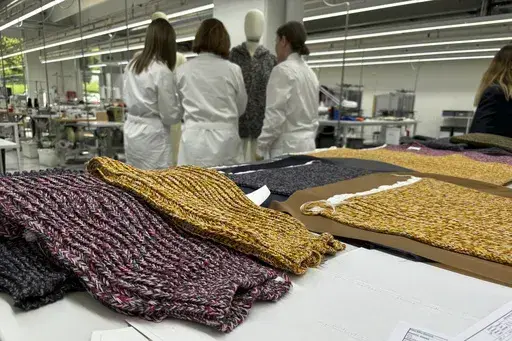 Knitwear created by Italian artisans for the Prada and Miu Miu brands sit on a desk at a recently expanded factory in the Perugia province of Italy, Tuesday, May 7, 2024. The Prada Group is expanding its production footprint in Italy, including dozens of new jobs at brand's knitwear factory near Umbria, leaning into Made in Italy as integral to the brand's ethos as it develops new artisanal talent to ease the luxury group through a generational shift in its workforce, alongside the management an