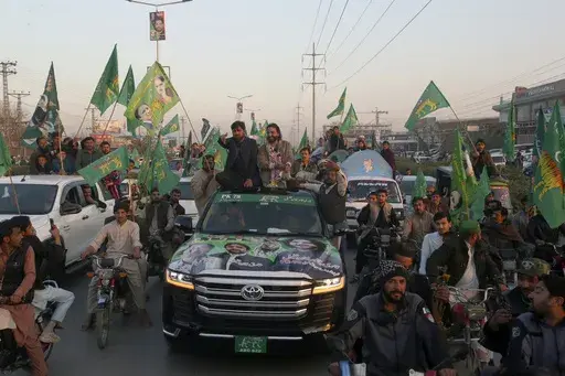Qari Zahir Shah, center right on vehicle, a winning candidate from Pakistan's former prime minister Nawaz Sharif's party 'Pakistan Muslim League-N, leads rally with his supporters to celebrate his victory in the parliamentary elections, in Peshawar, Pakistan, Sunday, Feb. 11, 2024. (AP Photo/Muhammad Sajjad)