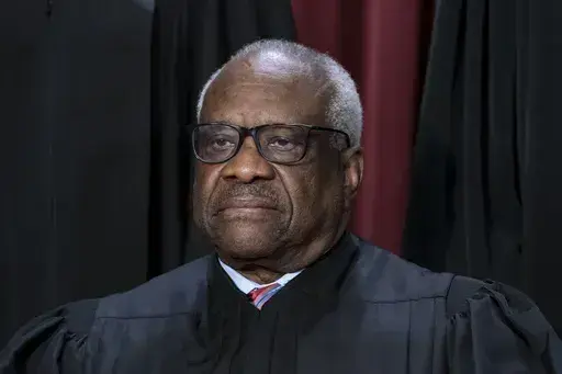 Associate Justice Clarence Thomas joins other members of the Supreme Court as they pose for a new group portrait, at the Supreme Court building in Washington, Oct. 7, 2022. Thomas is acknowledging that he took three trips last year aboard a private plane owned by Republican megadonor Harlan Crow. It’s the first time in years that Thomas has reported receiving hospitality from Crow. (AP Photo/J. Scott Applewhite, File)
