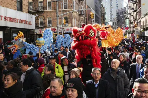 Revelers gather to attend the parade for the Chinese New Year "The Dragon" in the Chinatown neighborhood of Manhattan, Sunday, Feb. 25, 2024, in New York. (AP Photo/Eduardo Munoz Alvarez)