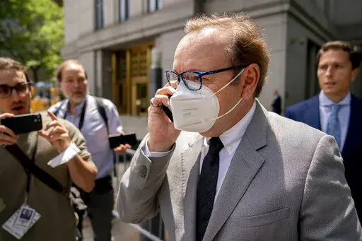 Kevin Spacey leaves court after testifying in a civil lawsuit, Thursday, May 26, 2022, in New York. British prosecutors have charged Spacey with four counts of sexual assault against three men. The 62-year-old double Academy Award winner was questioned by British police in 2019 about claims by several men that he had assaulted them. The U.K. charges were announced Thursday, as Spacey was testifying in a courtroom in New York City in a civil lawsuit. (AP Photo/John Minchillo)