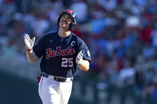 Mississippi's Tim Elko (25) runs the bases after hitting a home run against Arkansas in the first inning during an NCAA College World Series baseball game, Monday, June 20, 2022, in Omaha, Neb. (AP Photo/John Peterson)