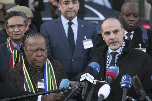 Accompanied with South Africa's Foreign Minister Naledi Pandor, left, Palestinian assistant Minister of Multilateral Affairs Ammar Hijazi addresses reporters after session of the International Court of Justice, or World Court, in The Hague, Netherlands, Friday, Jan. 26, 2024. The United Nations' top court has stopped short of ordering a cease-fire in Gaza in a genocide case but demanded that Israel try to contain death and damage in its military offensive in the tiny coastal enclave. South Afric
