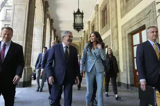 U.S. Homeland Security Secretary Kristi Noem, right, walks with Mexican Foreign Minister Juan Ramon de la Fuente at the National Palace in Mexico City, Friday, March 28, 2025. (AP Photo/Alex Brandon)