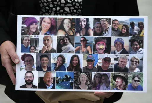 A photo collage of the 34 victims of the Sept. 2, 2019 fire aboard the dive boat, Conception, at Santa Cruz Island, is held by a family member arriving at federal court in Los Angeles, Wednesday, Oct. 25, 2023. A federal jury on Monday, Nov. 6, found scuba dive boat captain Jerry Boylan was criminally negligent in the deaths of 34 people killed in a fire aboard the vessel in 2019, the deadliest maritime disaster in recent U.S. history. (AP Photo/Damian Dovarganes,File)
