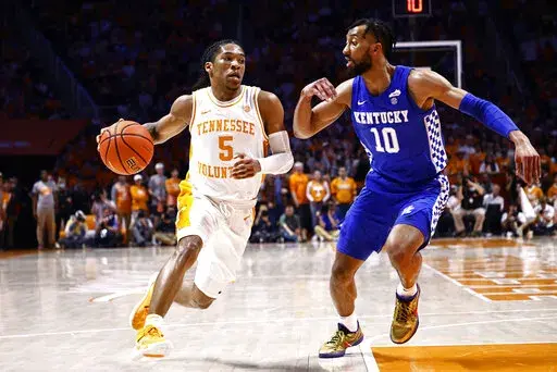 Tennessee guard Zakai Zeigler (5) drives against Kentucky guard Davion Mintz (10) during the first half of an NCAA college basketball game Tuesday, Feb. 15, 2022, in Knoxville, Tenn. (AP Photo/Wade Payne)