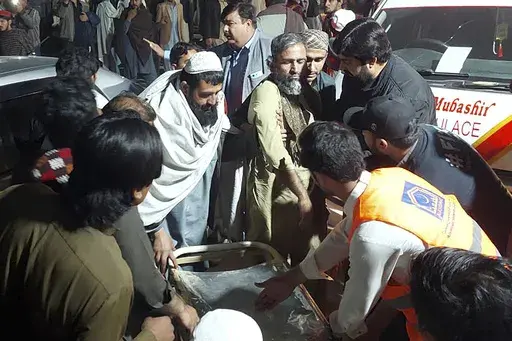 Rescue workers and volunteers help victims of a bomb explosion upon his arrival at a hospital, in Bannu, northwest Pakistan, Tuesday, March 4, 2025. (AP Photo/Ehsan Ullah Khan)