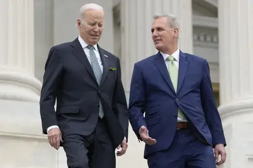 President Joe Biden talks with House Speaker Kevin McCarthy of Calif., as they walk down the House steps as they leave after attending an annual St. Patrick's Day luncheon gathering at the Capitol in Washington, March 17, 2023. The Tuesday, May 9, White House sitdown between the president and congressional leaders will be the first substantive talks between Biden and McCarthy in months, and comes weeks after House Republicans voted on a bill that would raise the debt limit but impose significant