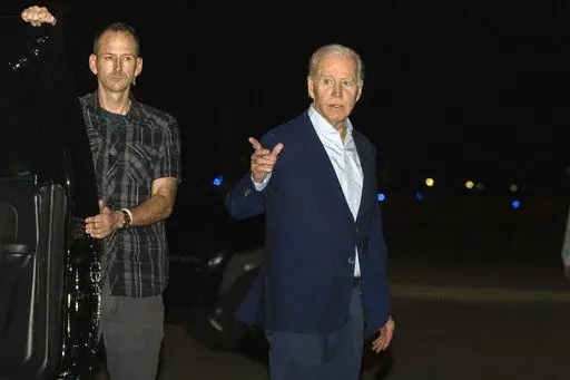 President Joe Biden arrives at Henry E. Rohlsen Airport, in St. Croix, U.S. Virgin Islands, late Tuesday, Dec. 27, 2022. Biden on Thursday signed a $1.7 trillion spending bill that will keep the federal government operating through the end of the federal budget year in September 2023, and provide tens of billions of dollars in new aid to Ukraine for its fight against the Russian military. (AP Photo/Manuel Balce Ceneta, File)