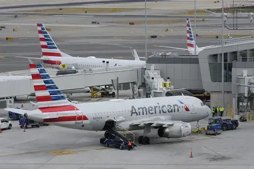 American Airlines planes sit on the tarmac at Terminal B at LaGuardia Airport, Jan. 11, 2023, in New York. American Airlines is raising bag fees and pushing customers to buy tickets directly from the airline if they want to earn frequent-flyer points. American said Tuesday, Feb. 20, 2024, that checking a bag on domestic flights will rise from $30 now to $35 online, and it'll be $40 if purchased at the airport. (AP Photo/Seth Wenig, File)