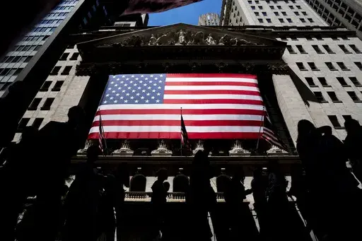 People walk past the New York Stock Exchange on Wednesday, June 29, 2022 in New York. Wall Street pointed higher before the open Friday, Nov. 17, 2023, as most major markets looked set to end the week with solid gains. (AP Photo/Julia Nikhinson)