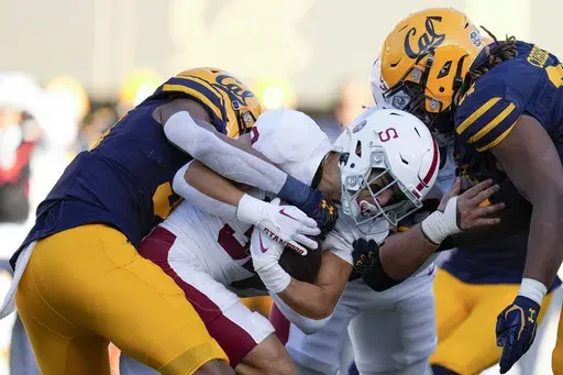 Stanford running back Mitch Leigber, middle, runs the ball against California during the first half of an NCAA college football game in Berkeley, Calif., Saturday, Nov. 19, 2022. Atlantic Coast Conference presidents and chancellors held a conference call Tuesday, Aug. 8, 2023, but took no action on West Coast expansion with California and Stanford, a person with knowledge of the situation told The Associated Press. (AP Photo/Godofredo A. Vásquez, File)