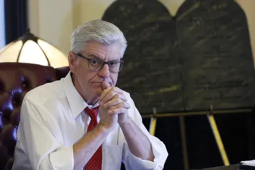 Gov. Phil Bryant ponders a response to a question regarding his legacy following a life of public service, while sitting in his Jackson, Miss., Capitol office, on Jan. 8, 2020. The former governor said Wednesday, May 3, 2023, that he will release all of his text messages related to a welfare fraud investigation — including money spent on building a university volleyball arena, a project backed by retired NFL quarterback Brett Favre and others with connections to Bryant. (AP Photo/Rogelio V. So