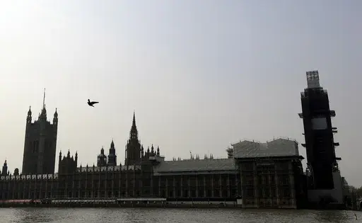 Britain's Houses of Parliament, covered in hoarding and scaffolding as it undergoes restoration work to repair the crumbling building, in London, Wednesday, April 17, 2019. British lawmakers are warning that the country's Parliament building is at “real and rising” risk of destruction. The House of Commons Public Accounts Committee said Parliament is “leaking, dropping masonry and at constant risk of fire,” as well as riddled with asbestos. The committee said Wednesday, May 17, 2023 that