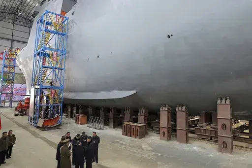 In this undated photo provided on March 8, 2025, by the North Korean government, North Korean leader Kim Jong Un, bottom right, visits a shipyard to construct warships at an undisclosed place in North Korea. Independent journalists were not given access to cover the event depicted in this image distributed by the North Korean government. The content of this image is as provided and cannot be independently verified. (Korean Central News Agency/Korea News Service via AP)