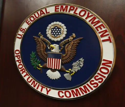 The emblem of the U.S. Equal Employment Opportunity Commission is shown on a podium in Vail, Colo., Tuesday, Feb. 16, 2016, in Denver. Pregnant workers have the right to a wide range of accommodations under new federal regulations for implementing the Pregnant Workers Fairness Act. The regulations take an expansive view of conditions related to pregnancy, from fertility treatments to abortion and post-childbirth complications. (AP Photo/David Zalubowski, File)