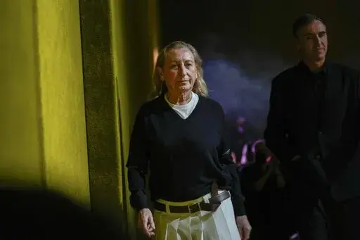 Miuccia Prada, left, and Raf Simons depart after the Prada Fall/Winter 2022-2023 fashion collection, unveiled during the Fashion Week in Milan, Italy, Thursday, Feb. 24, 2022. The Prada fashion house began charting a line of succession on its business side, announcing Tuesday, Dec. 6, 2022 that it is tapping a former LVMH executive as its next CEO, while confirming that Miuccia Prada will continue in her creative roles. Andrea Guerra is set to be confirmed by the board next month as the new CEO,