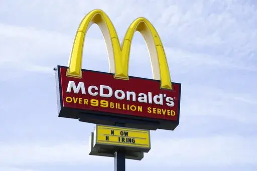A sign is displayed outside a McDonald's restaurant, Tuesday, April 27, 2021, in Des Moines, Iowa.  McDonald’s said Tuesday, March 8, 2022,  it is temporarily closing all of its 850 restaurants in Russia in response to the country's invasion of Ukraine. The burger giant said it will continue paying its 62,000 employees in Russia.  (AP Photo/Charlie Neibergall, File)