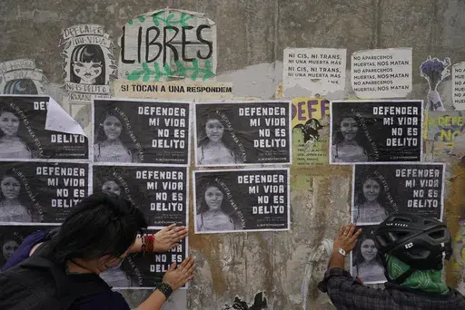 Activists paste photos of Roxana Ruiz that read in Spanish "Defending my life is not a crime" on a wall near the court building where the 22-year-old attends a hearing where she is charged with homicide with excess of legitimate self-defense in Chimalhuacan, State of Mexico, Mexico, Abril 18, 2022. Ruiz, who killed a man defending herself when he attacked and raped her in 2021 was sentenced to more than six years in prison, a decision her legal defense called “discriminatory” and vowed to ap
