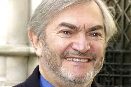 British composer Monty Norman is seen in this March 19, 2001 photo. Norman, who wrote the theme tune for the James Bond films, has died. He was 94. A statement posted Monday on Norman's official website said: "It is with sadness we share the news that Monty Norman died on 11th July 2022 after a short illness." (Kirsty Wigglesworth/PA via AP)