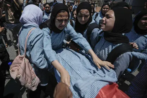 The classmates of 15-year-old Sadeel Naghniyeh carry her body during her funeral in the West Bank Jenin refugee camp Wednesday, June 21, 2023. The death of a 15-year-old girl who was killed by suspected Israeli fire during an Israeli military raid on June 19, is renewing scrutiny of Israel's record of causing civilian deaths during a more than yearlong crackdown on militants in the occupied West Bank. (AP Photo/Majdi Mohammed, File)
