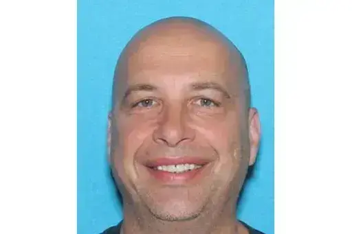 This drivers license image contained in the Statement of Facts supporting an arrest warrant, released by the Justice Department, shows Robert Sanford. Sanford, a retired firefighter who threw a fire extinguisher at police officers during the U.S. Capitol riot on Jan. 6, 2021, has been sentenced to more than four years in prison. (Justice Department via AP)