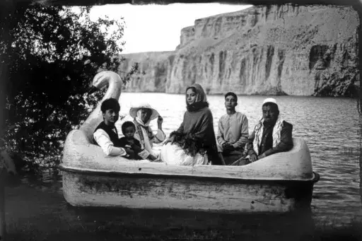 The Moradi family sits for a portrait on a small boat in Band-i-Mir lake, one of the tourist attractions in the Bamiyan Valley region in Afghanistan, Saturday, June 17, 2023. The family traveled a long way from Helmand to spend a few days for their summer vacation. During their first stint in power from 1996 to 2001, the Taliban banned photography of humans and animals as contrary to the teachings of Islam. Many box cameras were smashed, though some were quietly tolerated, Afghan photographers s