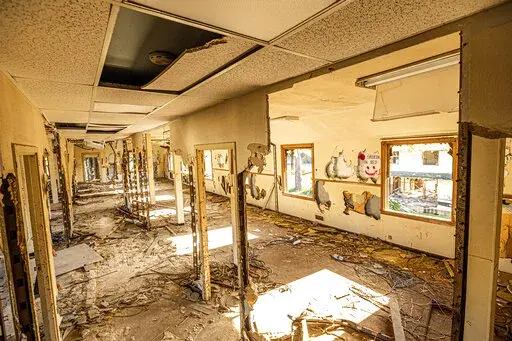 The remains of a hallway stretches down the center of barracks at Fort Ord on Thursday, April 29, 2021, in Fort Ord, Calif. Many veterans of Fort Ord who believe their cancers were caused by exposure to chemicals at the base have been denied disability and medical benefits from the Department of Veterans Affairs. (AP Photo/Noah Berger)
