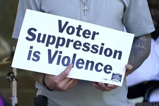 A person previously convicted of a felony felon holds a sign about voter suppression during a Poor People's Campaign assembly in Jackson, Miss., on Monday, April 19, 2021. The demonstrator was among speakers who called for Mississippi to simplify the way it restores voting rights to people convicted of some felonies. On Friday, June 30, 2023, the U.S. Supreme Court said it would not consider a case challenging Mississippi's practice of removing voting rights from people convicted of some crimes.