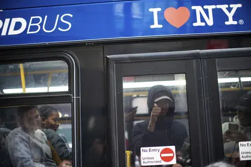 Asylum seekers arrive at the Roosevelt Hotel on Friday, May 19, 2023, in New York. Three New York City boroughs lost almost 80,000 residents from people moving away last year, according to population estimates released Thursday, March 14, 2024, but city officials think those numbers are a major undercount that didn't capture the influx of asylum seekers who came to the city.(AP Photo/Eduardo Munoz Alvarez)