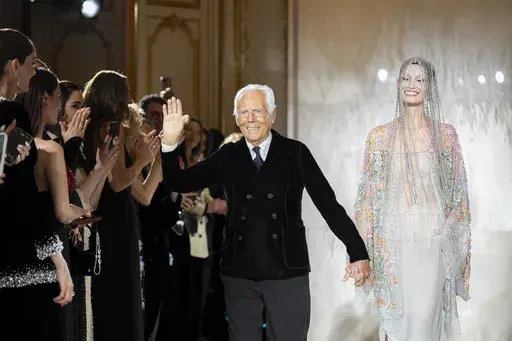 Giorgio Armani accepts applause at the end of the Giorgio Armani Prive Haute Couture Spring Summer 2025 collection, that was presented in Paris, Tuesday, Jan. 28, 2025. (AP Photo/Lewis Joly).