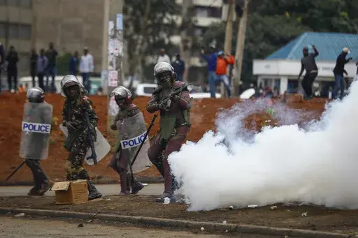 Riot police fire tear gas grenades at demonstrators during protests in the capital Nairobi, Kenya on July 7, 2023. The United States is praising Kenya's interest in leading a multinational force in Haiti. But weeks ago, the U.S. openly warned Kenyan police officers against violent abuses. Now 1,000 of those police officers might head to Haiti to take on gang warfare. (AP Photo/Brian Inganga, File)