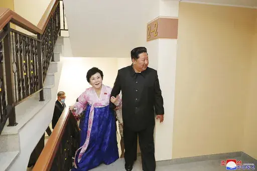 In this photo provided by the North Korean government, Kim Jong Un visits the new house of Korean Central Broadcasting announcer Ri Chun Hi, second right, after attending an inauguration ceremony of Pothong riverside terraced residential district in Pyongyang, North Korea Wednesday, April 13, 2022. Independent journalists were not given access to cover the event depicted in this image distributed by the North Korean government. The content of this image is as provided and cannot be independently