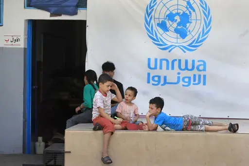 Palestinian children who fled with their parents from their houses in the Palestinian refugee camp of Ein el-Hilweh, gather in the backyard of an UNRWA school, in Sidon, Lebanon, Sept. 12, 2023. An independent review released Monday, April 22, 2024, of the neutrality of UNRWA, the U.N. agency helping Palestinian refugees, has found that Israel never expressed concern about anyone on the staff lists it has received annually since 2011. The review was carried out after Israel alleged that a dozen 