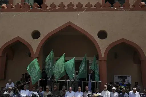 Hamas supporters and masked militants from the Izzedine al-Qassam Brigades, the military wing of Hamas, wave the green flags of the Islamist group during a protest in support of Palestinian prisoners in Israeli jails, after Friday prayer in Nusseirat refugee camp, central Gaza Strip, Friday, Aug. 18, 2023. It has become an Israeli mantra throughout the latest war in Gaza: Hamas is ISIS. Since the bloody Hamas attack on Oct. 7 that triggered the war, Israeli leaders and commanders have likened th