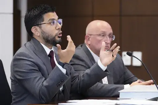 Attorney George Gomez, left, speaks to Judge George D. Strickland as Robert E. Crimo Jr., listens during an appearance at the Lake County Courthouse, Monday, Aug. 7, 2023, in Waukegan, Ill. (AP Photo/Nam Y. Huh, Pool)