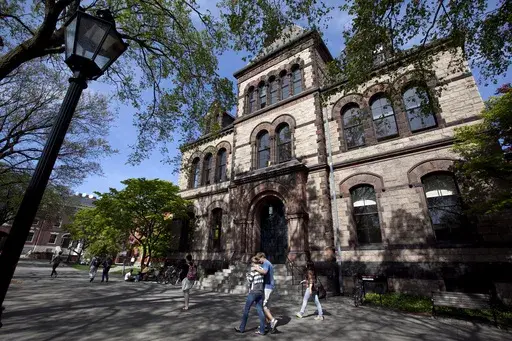Passersby walk past Sayles Hall on Brown University's campus in Providence, R.I., May 7, 2012. (AP Photo/Steven Senne, File)