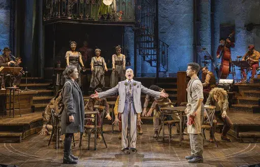 This image released by DKC/O&M shows Jon Jon Briones, center, and his daughter Isa Briones, left, and Jordan Fisher, right, and the cast during a performance of "Hadestown" in New York. (Evan Zimmerman for MurphyMade/DKC/O&M via AP)