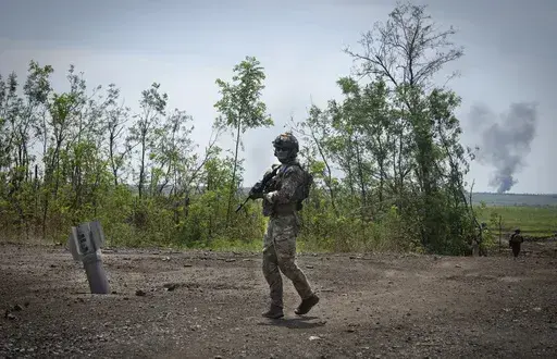 Ukrainian soldiers walk in their positions on the frontline in Zaporizhzhia region, Ukraine, Friday, June 23, 2023. In the southeastern Zaporizhzhia region, Ukrainian troops - backed by tanks, artillery and drones - have broken through initial Russian fighting positions and continue to make steady gains south of Velyka Novosilka near the administrative border with Donestk and south of Orikhiv, while confronting heavy bombardment in wide open fields with little cover. (AP Photo/Efrem Lukatsky, Fi