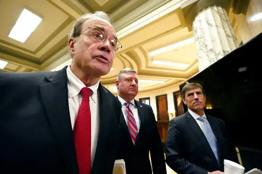 Lt. Gov. Delbert Hosemann, left, speaks to reporters alongside Senate Appropriations Committee member Dennis DeBar Jr., R-Leakesville, center, and Senate Appropriations Committee Chairman Briggs Hopson, R-Vicksburg, about proposed legislation to fully fund the Mississippi Adequate Education Program (MAEP) and inject an additional $181.1 million into school budgets, following a meeting of the committee Monday, March 6, 2023, at the Mississippi Capitol in Jackson. (AP Photo/Rogelio V. Solis)