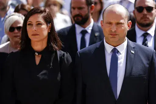 Israeli Prime Minister Naftali Bennett and his wife Gilat take part in the ceremony marking Holocaust Remembrance Day at Warsaw Ghetto Square at the Yad Vashem memorial in Jerusalem, Thursday, April 28, 2022. (Amir Cohen/Pool Photo via AP)